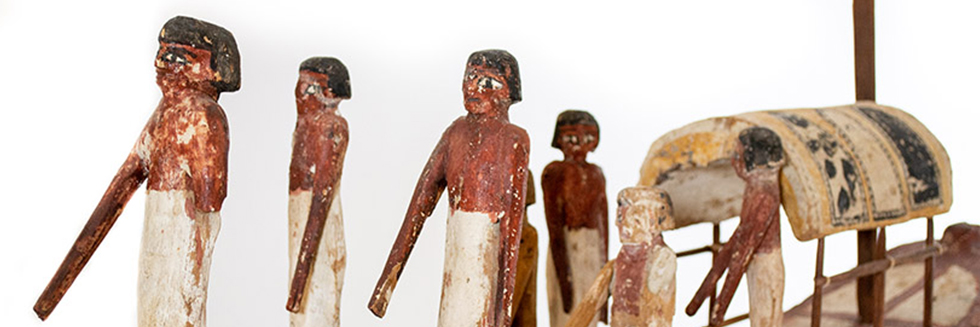 Ancient Egyptian model of people on a boat.