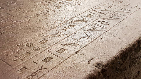 A stone with heiroglyphic markings.