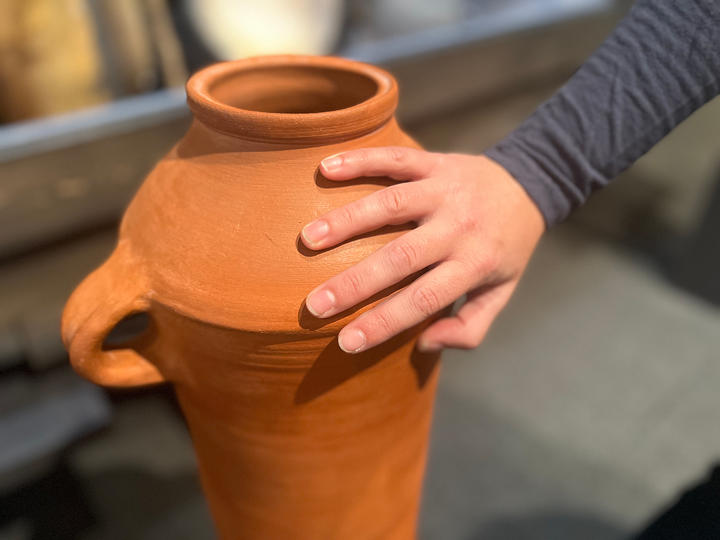 hand on replica amphora in the gallery.