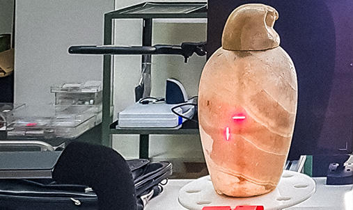 Canopic jars being scanned for content.