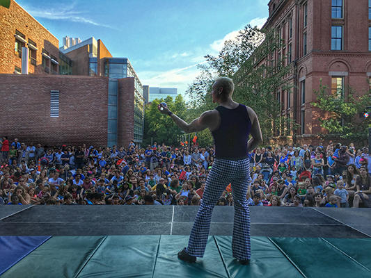 Performer on stage in front of large crowd