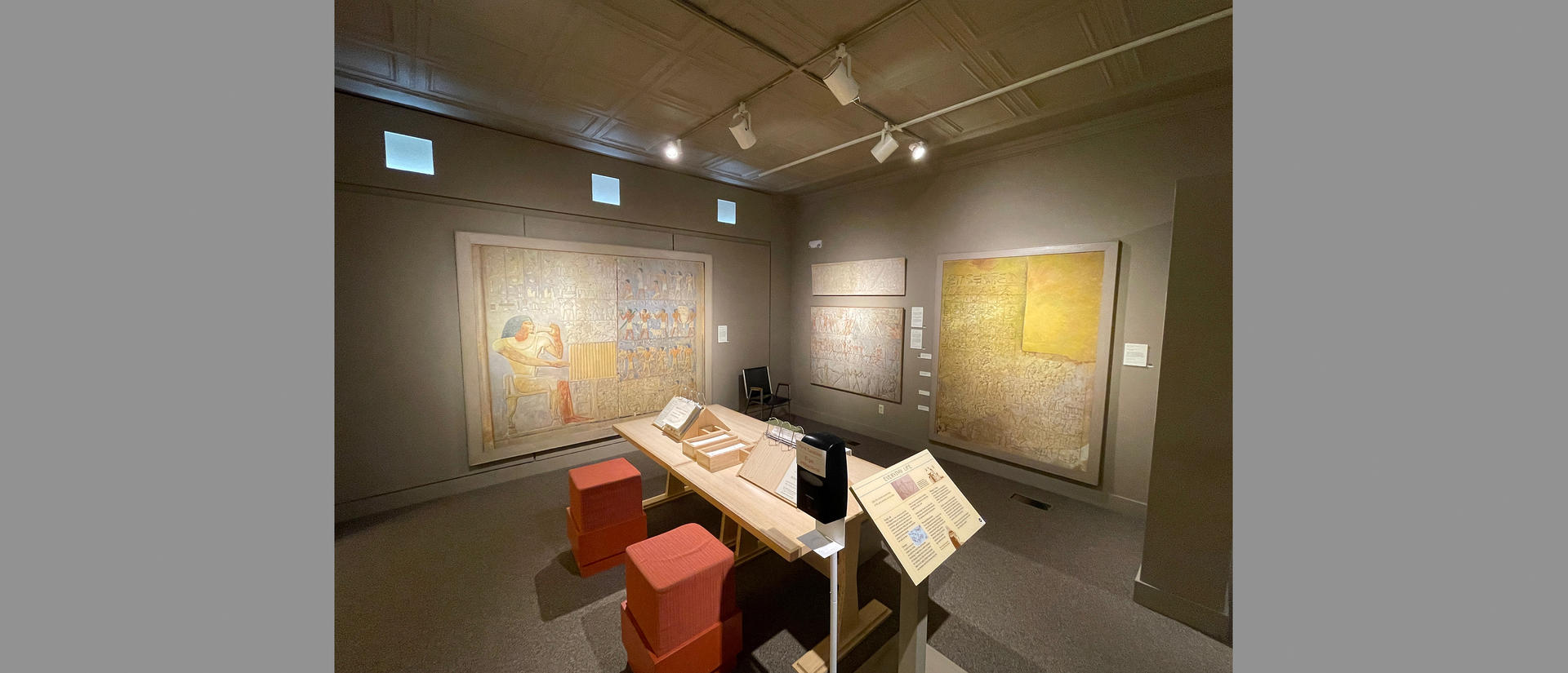 paintings and seating area in gallery.
