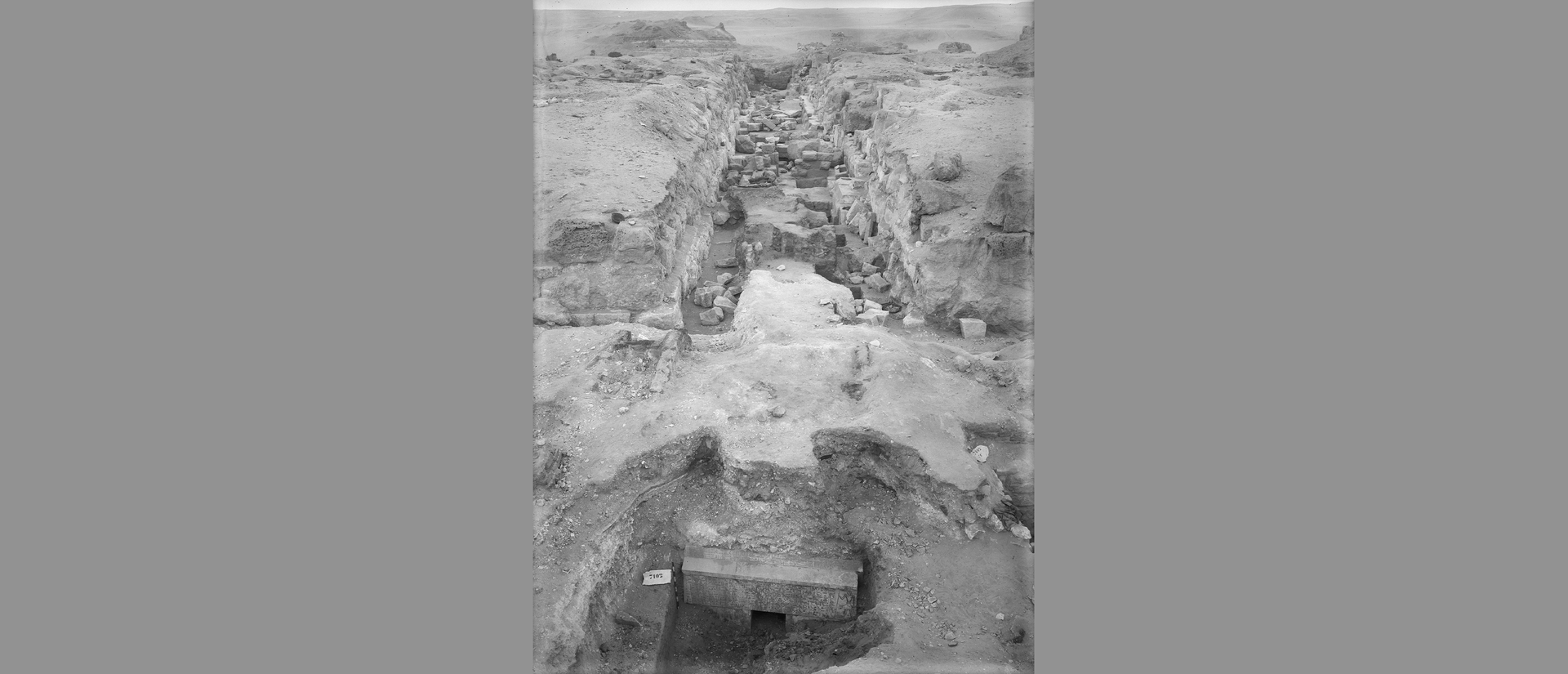 wide overhead video of entrance to idu's tomb and long excavated trench beyond.