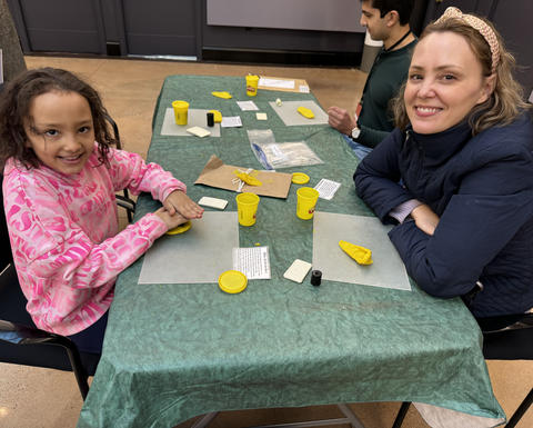 A family plays with clay at a previous iteration of this event.